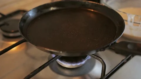 A man prepares himself breakfast in the kitchen, delicious pancakes Stock Footage 151691138