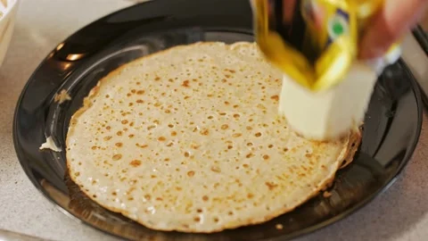 A man prepares himself breakfast in the kitchen, delicious pancakes Stock Footage 151691184
