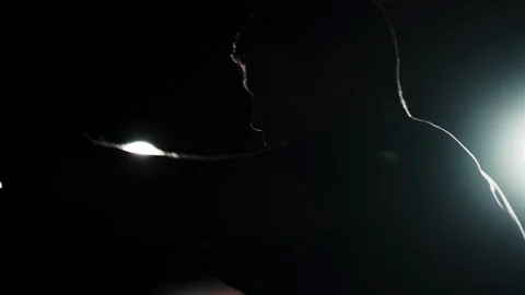 A man prepares to hit an opponent against a dark background. Stock Footage 256745860