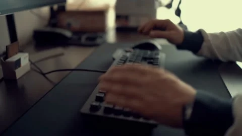 Man prepares keyboard on desk and thinks before typing with fingers indoors Stock Footage 146984275