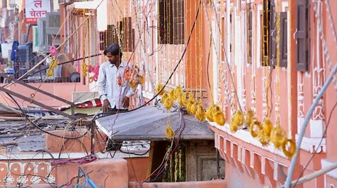 Man prepares light strands used for celebration of wedding in Jaipur, India. Stock Footage 37518138