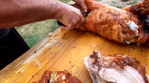 A man prepares meat for lunch and cuts it Stock Footage 143644464
