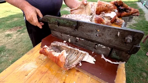 A man prepares meat for lunch and cuts it Stock Footage 143644652