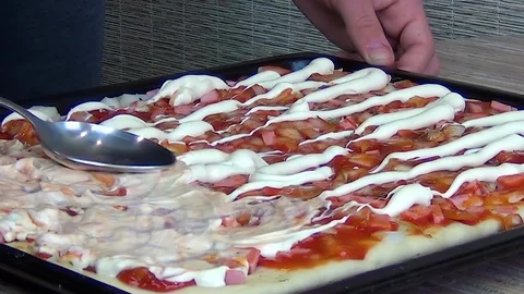 A man prepares pizza Stock Footage 127690339