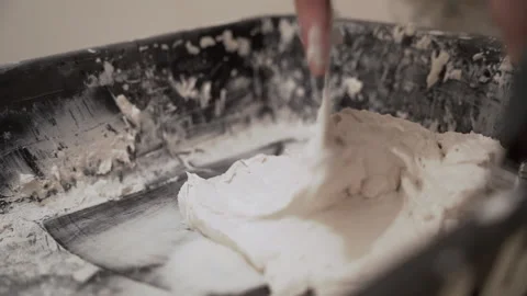 A man prepares plaster with a spatula Video stock 149127405