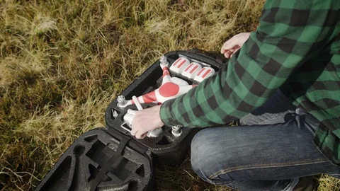 Man prepares quadrocopter for flight. 4k Видео 103264156