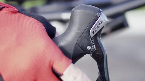 Man prepares to ride bicycle by squeezing brake Video stock 113483712