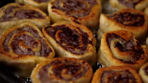 A man prepares a roll of dough stuffed with meat, onions and spices Stock Footage 136829997
