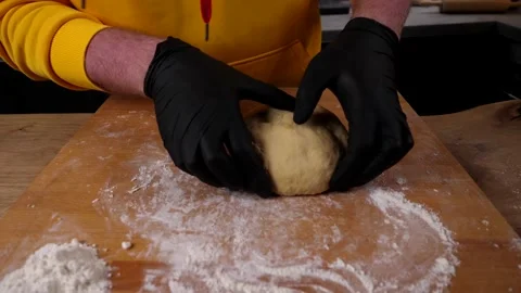 A man prepares a roll of dough stuffed with meat, onions and spices Video stock 136830421