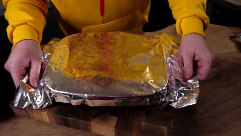 A man prepares a roll of dough stuffed with meat, onions and spices Stock Footage 136830608