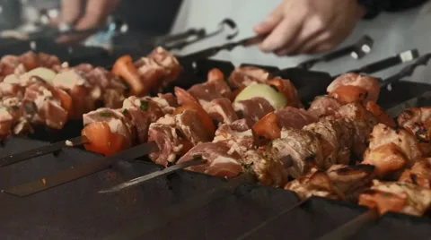 The man prepares a shish kebab on fire. Stock Footage 55358384