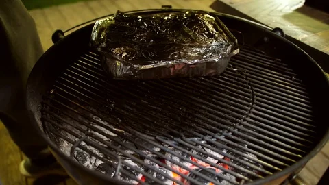 A man prepares smoked pork ribs with hot sauce on a barbecue Stock Footage 128657341