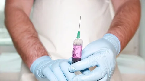 A man prepares a syringe for injection Stock Footage 100349525
