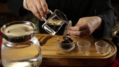 A man prepares tea according to a traditional recipe Stock Footage 104297585