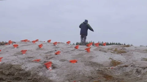 Man prepares wires for blasting on construction site. Explosive works, lay Stock Footage 69977844