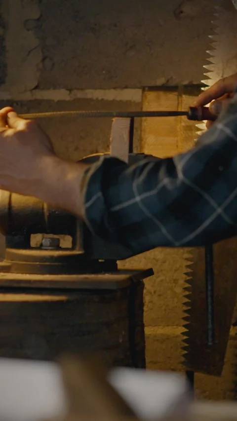 Man prepares wood for processing in a workshop with tools and equipment near Stock Footage 331643412