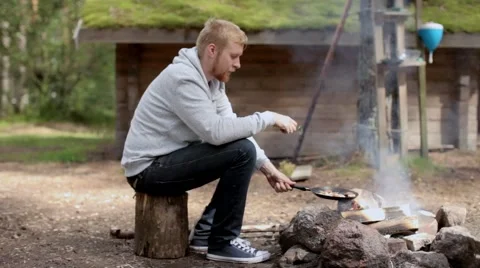 Man Preparesscrambled Eggs on Fire Video stock 67343107