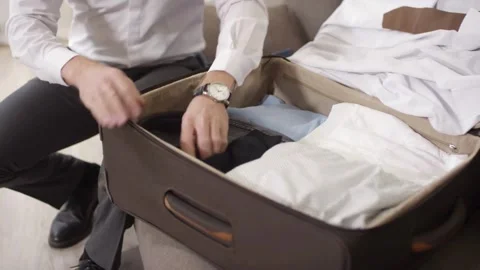 Man Preparing baggage for journey. Concept of traveling, adventure Stylish young Stock-Footage 336235793