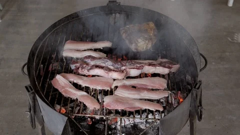 Man preparing a barbecue by day Stockbeeldmateriaal 106022646