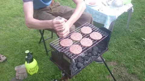 Man preparing barbecue on the grill Stock Footage 72498334