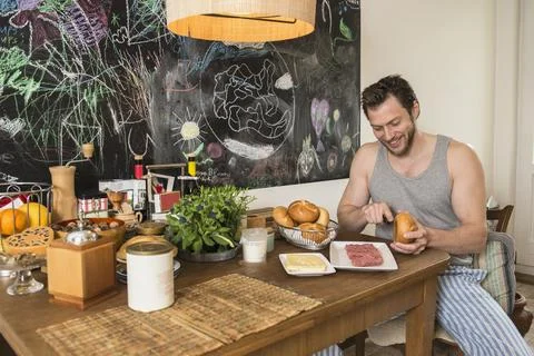 Man preparing breakfast in the kitchen, Munich, Bavaria, Germany Stock Photos