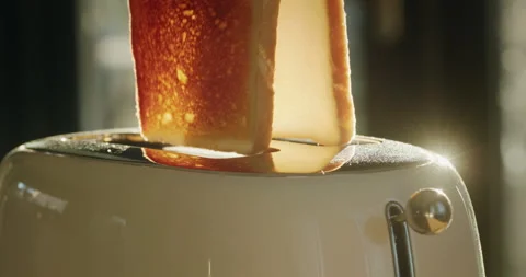 A man is preparing breakfast - loading bread into the toaster, croutons jumping Stock Footage 252821807
