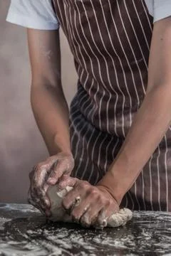 Man preparing buns at table in bakery Stock Photos