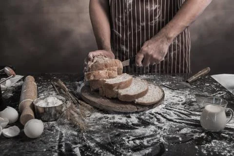 Man preparing buns at table in bakery Stock Photos