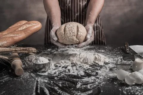 Man preparing buns at table in bakery 写真素材