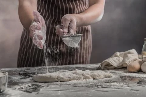 Man preparing buns at table in bakery Stock Photos