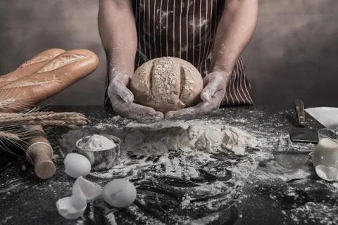 Man preparing buns at table in bakery Stock Photos