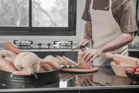 Man preparing buns at table in bakery 写真素材