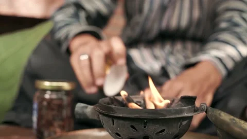 Man preparing to burn Arab Bakhoor incense Stock Footage 209853153