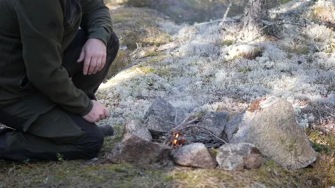 Man Preparing Campfire in Forest Building Fire with Stones 스톡 동영상 332720638