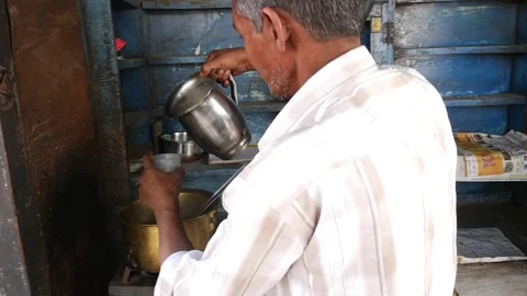 Man preparing chai from his shop along street in Jaipur, India Video stock 70363054