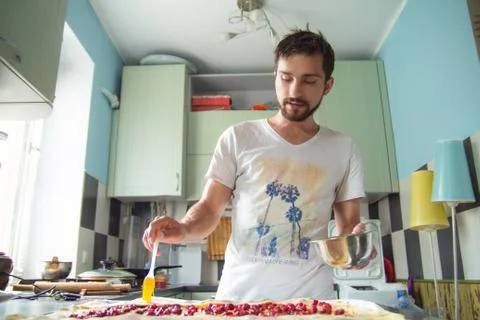 The man is preparing a cherry strudel Stock Photos