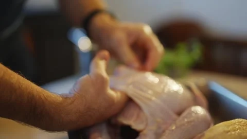 A man is preparing a chicken for cooking Stock Footage 295367590