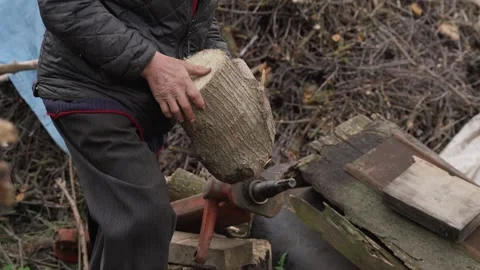 A man is preparing to chop firewood Stock Footage 259558988