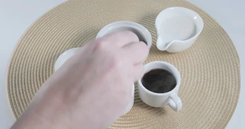 Man preparing coffee for breakfast and putting brown sugar in the cup Stock Footage 146646078
