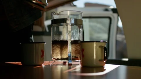 Man preparing coffee in campervan Stock Footage 107023276