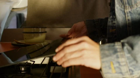 Man preparing coffee on stove in campervan Stock Footage 107023685