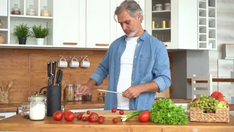 Man preparing to cook meat at kitchen, hands sharpening knife. Stock Footage 139744269