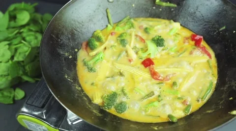 Man preparing curry vegetables with cocount milk on the wok pan 스톡 동영상 59847620