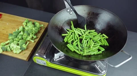 Man preparing curry vegetables on the wok pan Stock Footage 59847430