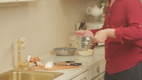 A man is preparing dinner at home in the kitchen Stock Footage 81423474