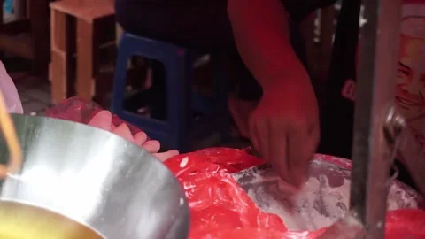 A man preparing a dish called 'Batagor' to customer on the street of Malang. Stock Footage 219464463