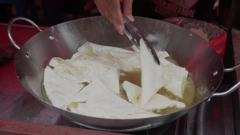 A man preparing a dish called 'Batagor' to customer on the street of Malang. Stock Footage 219464829