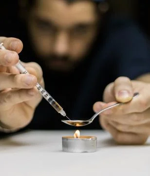 A man preparing a dose of cocaine. Stock Photos