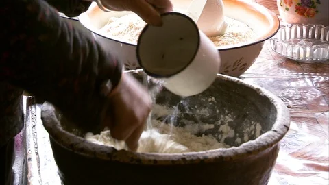 Man preparing dough in the bowl at kitchen Stockbeeldmateriaal 88333205