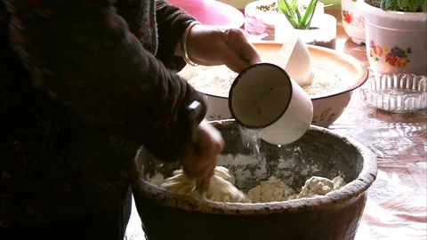 Man preparing dough in the bowl at kitchen Stock Footage 88334494